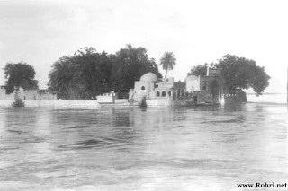 An image from 1883 showcases the revered shrine of Khwaja Khizr, also known as Jind Pir among Hindus, situated on a small island in Sindh. The shrine, a pilgrimage site for thousands, symbolizes the unity of Muslim and Hindu faiths. It stands as a historical testament to the region’s rich spiritual traditions and the enduring legacy of the saints who have been the embodiment of the Indus River’s spirit. An image from 1883 showcases the revered shrine of Khwaja Khizr, also known as Jind Pir among Hindus, situated on a small island in Sindh. The shrine, a pilgrimage site for thousands, symbolizes the unity of Muslim and Hindu faiths. It stands as a historical testament to the region’s rich spiritual traditions and the enduring legacy of the saints who have been the embodiment of the Indus River’s spirit.