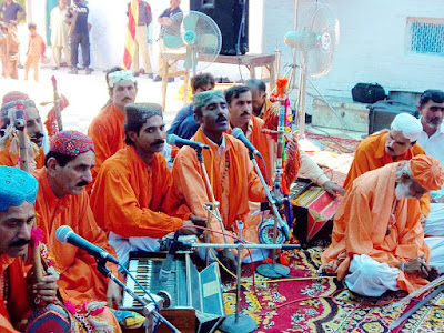 Vibrant Urs Celebration at Hazrat Bedil's Shrine Crowds of devotees gathered at the shrine of Hazrat Fakir Qadir Bakhsh Bidl Rohrdai during the annual Urs, with Sufi musicians performing Qawwali and langar (free meals) being distributed.