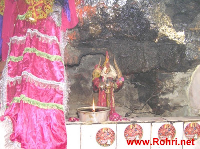 Devotees Lighting Lamps During Navratri Hindu worshippers offering oil lamps and flowers at Kalka Devi Temple during Navratri festival celebrations