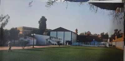 Sukkur Gymkhana Modern Building in Sukkur, Pakistan Modern Sukkur Gymkhana building in Sukkur, Pakistan, featuring a concrete facade and courtyard with street lamps, surrounded by greenery and a geometric-patterned border.