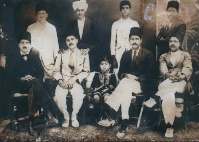 Group photograph with individuals seated from the right: Dr. Mirza Madad Ali Beg, Syed Abdul Hussain Shah Musavi, Qazi Ahmad Hussain (son of Dr. Qazi Ali Ahmad), Syed Atta Hussain Shah Musavi, and Dr. Qazi Ali Ahmad. Seated from the left: Mirza Ali Muhammad, Mirza Ali Bux Kausar, Mirza Gul Ahsan Karbalai, and Qazi Muhammad Hassan. Group photograph with individuals seated from the right: Dr. Mirza Madad Ali Beg, Syed Abdul Hussain Shah Musavi, Qazi Ahmad Hussain (son of Dr. Qazi Ali Ahmad), Syed Atta Hussain Shah Musavi, and Dr. Qazi Ali Ahmad. Seated from the left: Mirza Ali Muhammad, Mirza Ali Bux Kausar, Mirza Gul Ahsan Karbalai, and Qazi Muhammad Hassan.