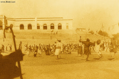 Local Elites and Protests at 1901 Sukkur Office Opening Archival photo from 1901 showing diverse attendees including Muslim scholars and Sufi representatives protesting near the inauguration site below Sukkur's DC Office, with the Treasury building visible and temporary tents for the event.