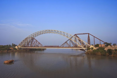 Clear Daytime Photo of Lansdowne Bridge Sukkur Pakistan: Engineering Marvel from Hollywood's Around the World in 80 Days Daytime view of Lansdowne Bridge in Sukkur, Pakistan, a historic cantilever railway bridge over the Indus River with a small boat and clear blue sky, used as a filming location in the 1956 movie Around the World in 80 Days