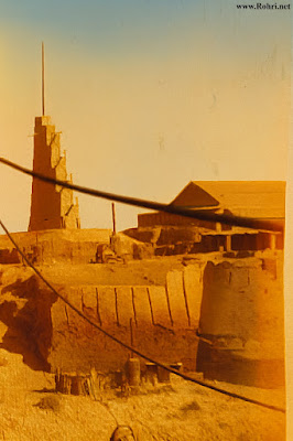 Bukkur Fort 1885 – Gunpowder Factory & Telegraph Tower Historic 1885 photograph of Bukkur Fort on the Indus River, with John Jacob’s gunpowder factory built over the former Mughal governor’s residence. During the construction of Lansdowne Bridge, the factory was converted into a workshop. Visible in the image is a tall tower with aerial equipment, part of the British Indian Telegraph system installed in 1860 to carry wireless lines across the river, with a total of four towers erected.