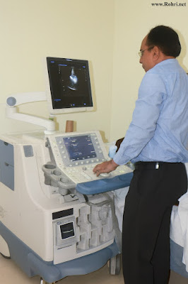 Hospital ward at Sukkur Civil Hospital with patient beds, IV drips, monitors, and medical equipment.